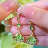 The light luxury and high-end green ginkgo leaf cat's eye stone long tassel earrings are fashionable and elegant, and are popular earrings for women