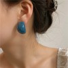 A girl with summer silver needle earrings made of colored acrylic, featuring a niche design, a fashionable and retro style, and a cold Korean style A girl with summer silver needle earrings made of colored acrylic, featuring a niche design, a fashionable and retro style, and a cold Korean style
